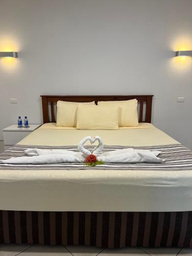 a bedroom with a bed with a weddingvisor on it at Garden Apartments in Nadi