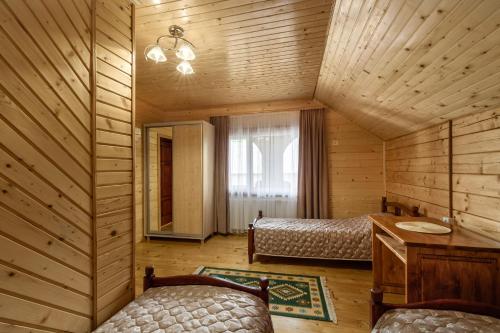 a bedroom with a bed and a desk in a room at Гостинний двір КАРПАТІЯ, Верховина in Verkhovyna