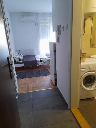 a bathroom with a washer and dryer in a room at Nikola NS in Novi Sad
