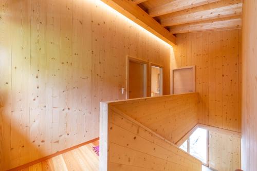 a wooden room with a staircase in a wooden house at Haus Regenbogen in Prägraten am Großvenediger