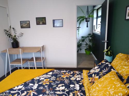 a bedroom with a bed and a desk and a table at Hall Street Haven in Te Awamutu