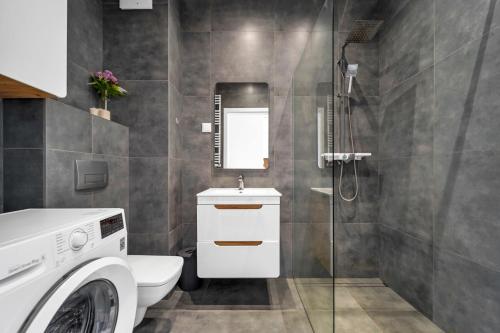 a bathroom with a toilet and a sink and a shower at Wawer Studio - Terrace, Workspace - by Rentujemy in Warsaw