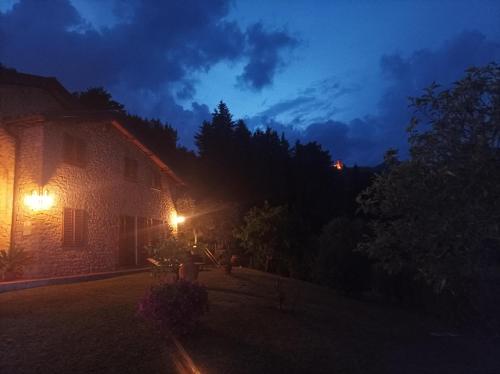 a house at night with lights on the side of it at Villa Camelia Tuscany in Pescia