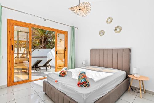 a bedroom with a bed and a balcony at AleSol Tenerife in Playa Fañabe