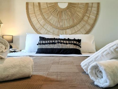 a bedroom with a bed with a large headboard at Funky Boho Kallithea Loft in Athens