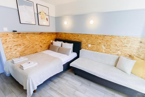 a hotel room with two beds and a couch at Fregata in Ustka