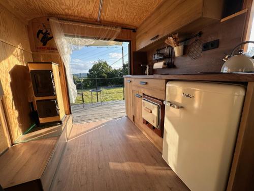 a kitchen with a refrigerator and a view of a deck at Ubytování Maringote 