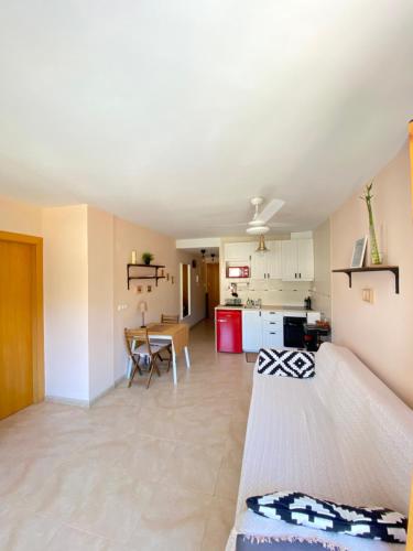 Las Vistas Apartment في غواداليست: غرفة معيشة مع أريكة ومطبخ