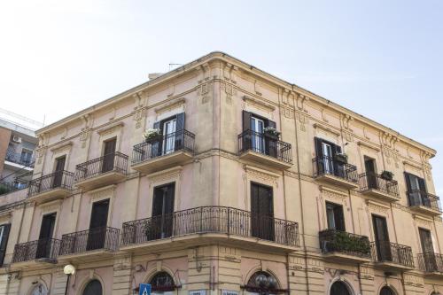 a large building with balconies on the side of it at Residence Le Vie del Centro in Matera