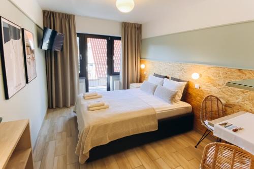 a hotel room with a large bed and a television at Fregata in Ustka