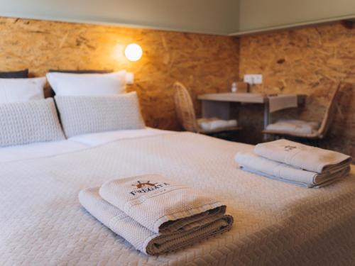 a hotel room with a bed with towels on it at Fregata in Ustka
