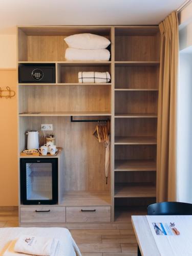 a walk in closet with a tv and shelves at Fregata in Ustka