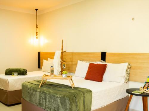 Habitación de hotel con 2 camas y mesa en Muda Hotel en Tianguá