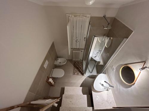 a bathroom with stairs and a toilet and a sink at Villa Aromata in Trudda