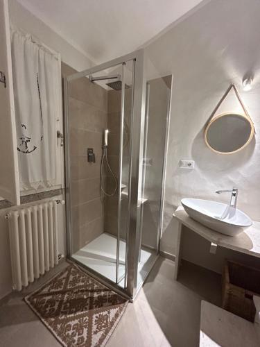 a bathroom with a glass shower and a sink at Villa Aromata in Trudda