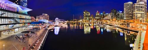 a city skyline at night with a body of water at Crowne Plaza Sydney Darling Harbour, an IHG Hotel in Sydney