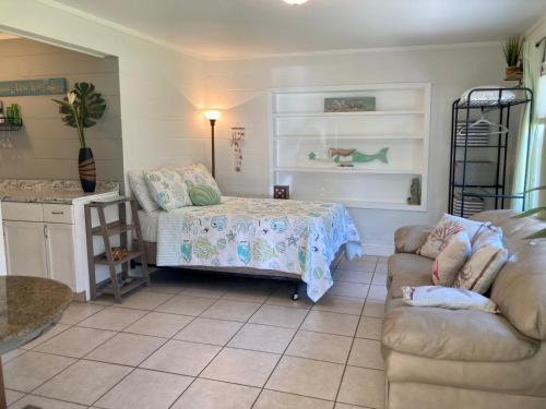 a living room with a bed and a couch at Seashell Studio near FIT/beach in Melbourne