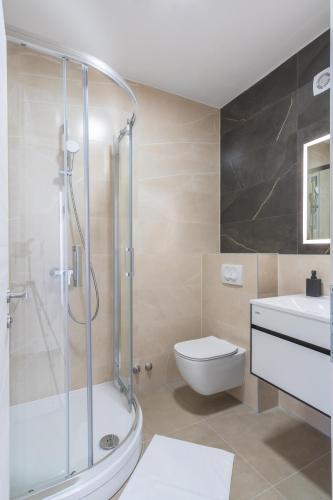 a bathroom with a shower and a toilet and a sink at Villa Lavanda in Novalja