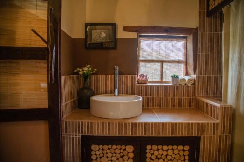 a bathroom with a sink and a window at Ayni Wasi in Coporaque