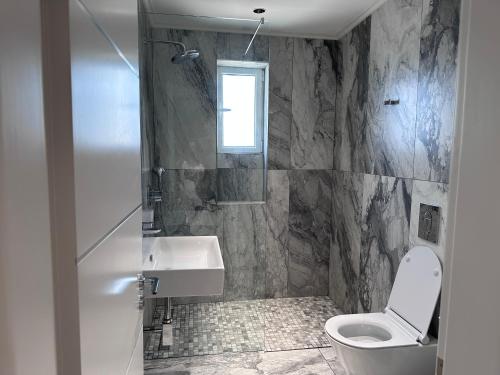 a bathroom with a toilet and a sink at SEAHOME-Apartment-Ksamil AL in Ksamil
