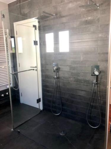 a shower in a bathroom with a glass door at Villa Ávilla. Luxo e Charme. in Cascais