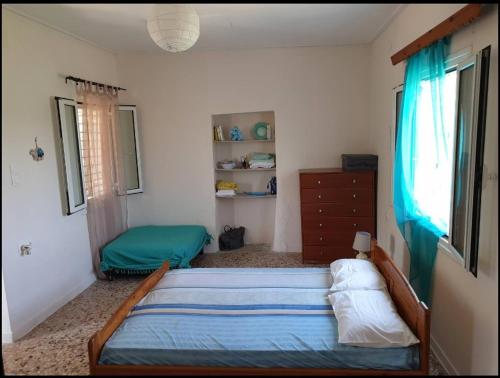 a bedroom with a bed and a dresser in it at Petrohori before midnight in Pylos