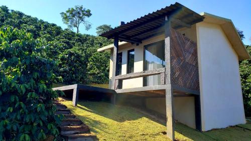 Divino de São Lourenço的住宿－Hospedagem Bangalô Patrimônio da Penha，山 ⁇ 旁带阳台的建筑