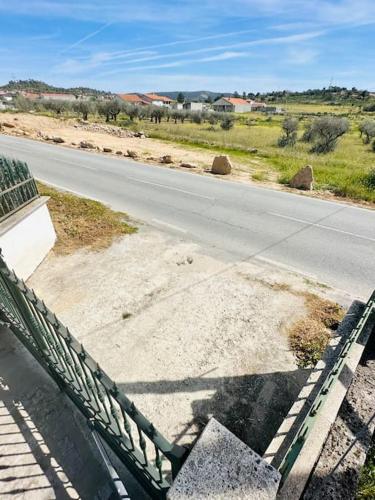 an empty road with a fence on the side of the road at Reis House in Torre de Dona Chama