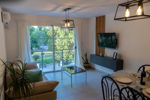 a living room with a table and a large window at In Calma Mdz in Mendoza