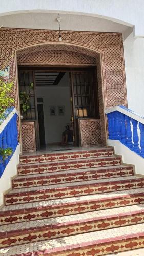 a set of stairs in front of a building at Casa Familia in Chefchaouene