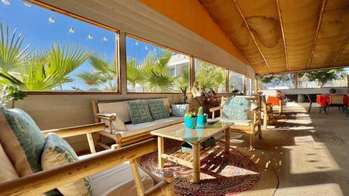 a screened in porch with chairs and a table at Hotel Del Valle Quilimari in Pichidangui