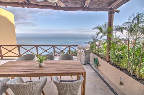 a patio with a table and chairs and the ocean at Punta Esmeralda - Beachfront with 8 Pools, Gym & Spa in Cruz de Huanacaxtle