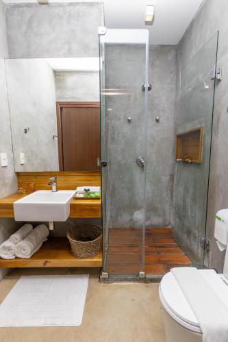a bathroom with a shower and a sink and a toilet at Flor de Lis Exclusive Hotel in Maceió
