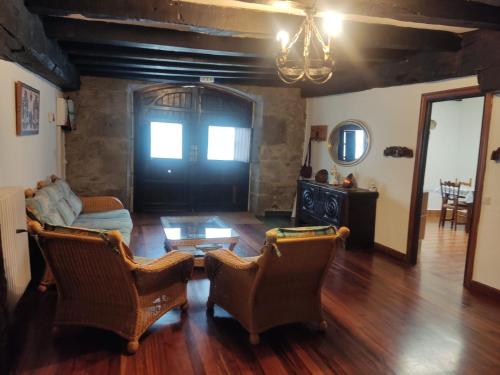 a living room with a couch and chairs and a table at Hermoso Caserío Navarra. (Madoz) 