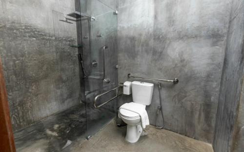 a bathroom with a toilet and a shower at Flor de Lis Exclusive Hotel in Maceió