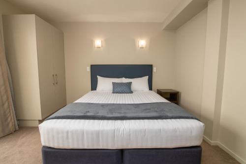 a bedroom with a large bed in a room at The Riverstone in Rangiora