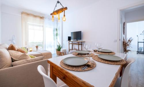 a living room with a table with plates on it at COZY BOHO HOUSE, Elegance & Comfort in Faro Center in Faro