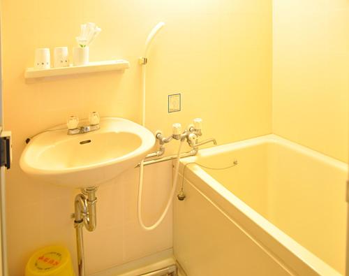 a bathroom with a sink and a bath tub at Koyokaku in Ureshino