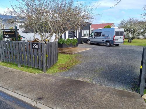 a van parked in a driveway next to a house at Harbourside 29B ~ Boat Parking in Coromandel Town