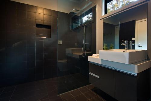 a bathroom with a white sink and a shower at Ablac House in Glenlyon