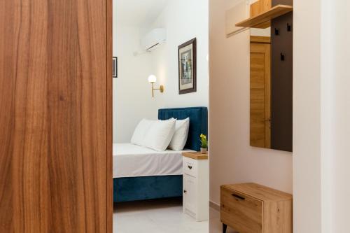 a bedroom with a bed and a mirror at Barba Apartments in Ulcinj