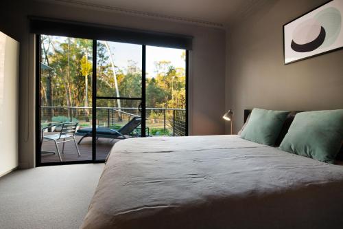 a bedroom with a large bed and a large window at Ablac House in Glenlyon