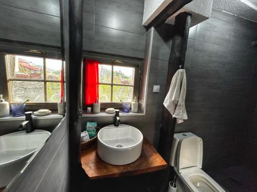 a bathroom with a white sink and a toilet at House of Sokolovi Kratovo in Kratovo