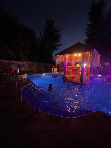 a swimming pool at night with a gazebo at Hotel Boutique Family Suites in Panguipulli