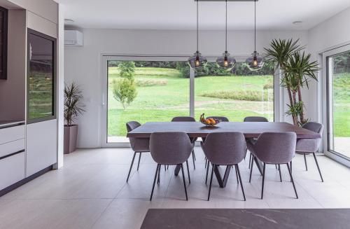 a dining room with a large table and chairs at Villa Olivetum in Sečovlje