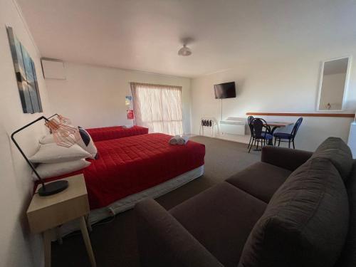 a hotel room with a bed and a couch at Alpine View Motel in Kaikoura