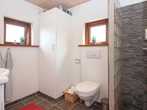 a bathroom with a toilet and a shower at 4 person holiday home in Glesborg in Glesborg