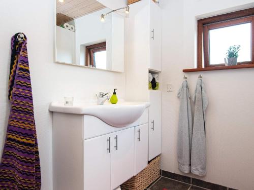 a bathroom with a sink and a mirror at 4 person holiday home in Glesborg in Glesborg