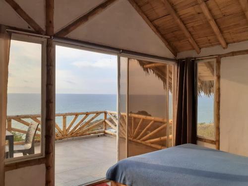 a bedroom with a view of the ocean at Casa Las Mantas in Santa Marianita