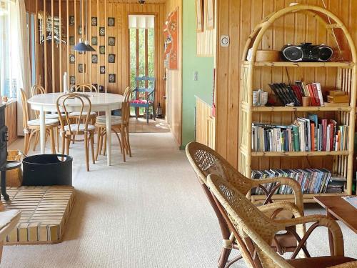 a room with a table and chairs and a book shelf at 4 person holiday home in Frørup-By Traum in Frørup